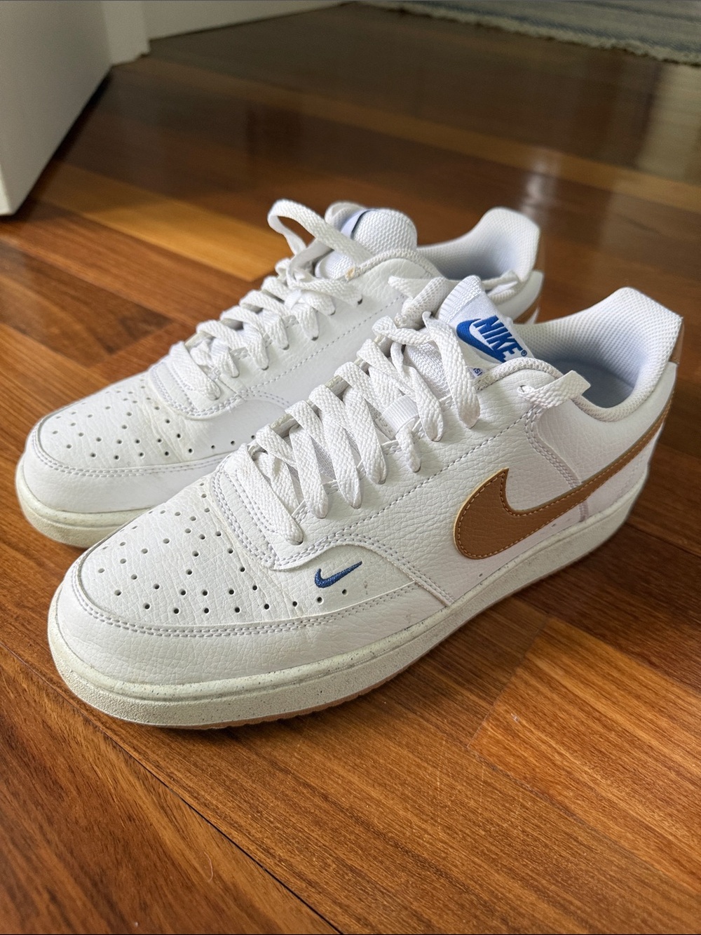 Nike White Low-Top Sneakers with Brown Swoosh and Blue Accents size 10.5
